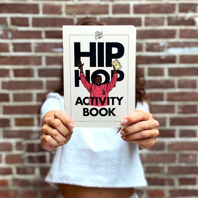 girl holding hip hop activity book